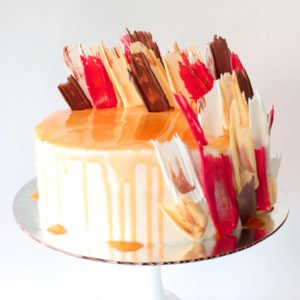 Drip Cake With Decorative Brush Stroke Fans in Brown, Red, White and Off-White