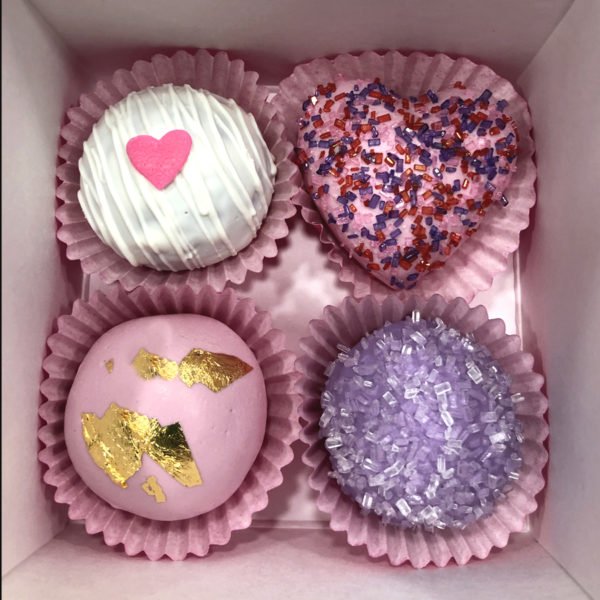 Valentine's Day Pink and Purple Cake Bites with edible gold and sprinkles.