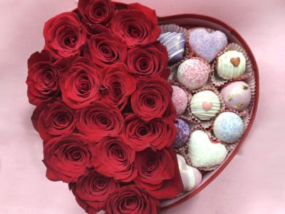 Beautiful box filled with valentine's day red roses and cake bites.