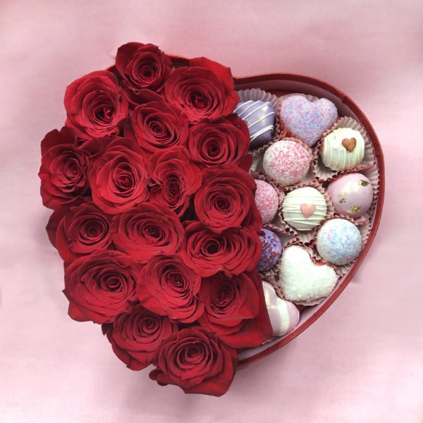 Beautiful box filled with valentine's day red roses and cake bites.