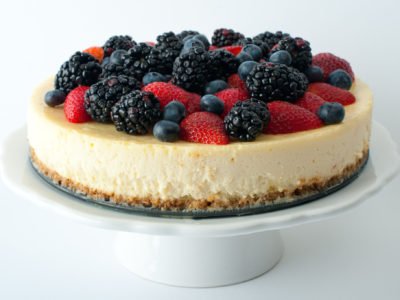 9" round cheesecakes with berries on top.